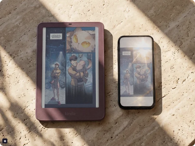 A Kindle and a smartphone side by side in sunlight, the Kindle screen clear and the phone screen washed out